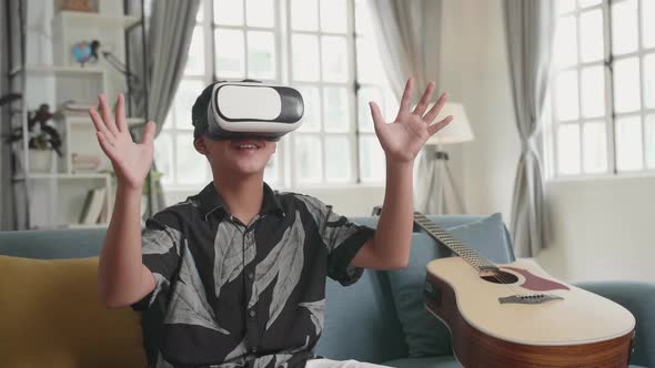 Asian Boy Explores Virtual Reality Device Interface