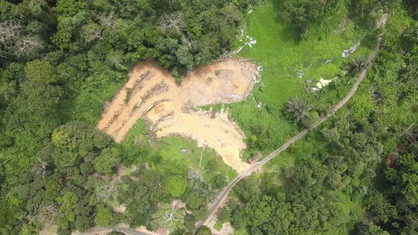 Aerial view of farms and road in the middle of jungle in Pahang