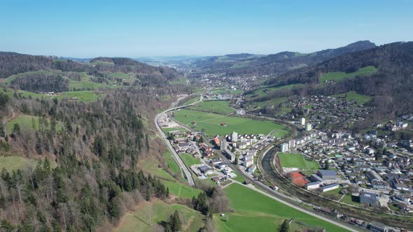 Panorama forward aerial over the city Wattwil located in a swiss valley.