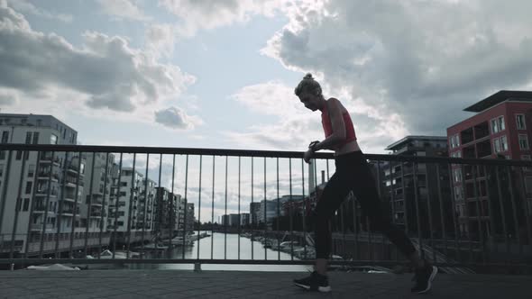 Senior Woman Running on Street with Smart Watch on Wrist