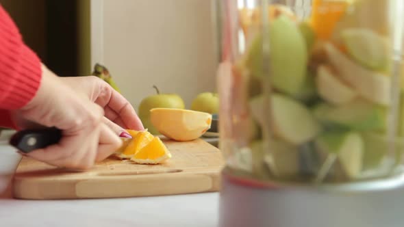 Putting Fruits In Blender. Cut Orange.