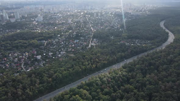 Megalopolis Next To the Forest: the Contact Between the Big City and Nature. Aerial View. Slow