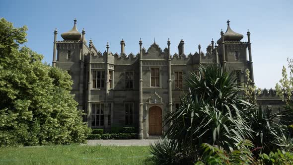 Video of an Old Beautiful Grey Castle Among a Green Garden on a Sunny Day