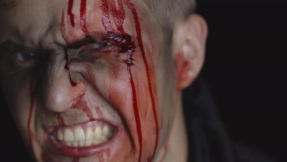 Halloween Man Portrait. Guy with Dripping Blood on His Face. Scary Makeup