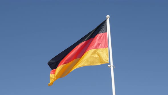 Recognizable   flag of Germany waving in front of blue sky 4K 2160p 30fps UHD footage - German natio