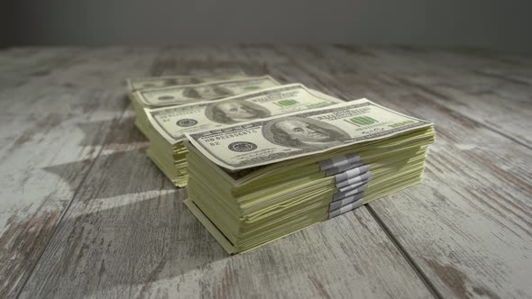 Lot of US Dollars on Wooden Background