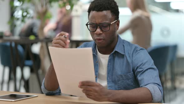 Young African Man Upset By Loss on Documents