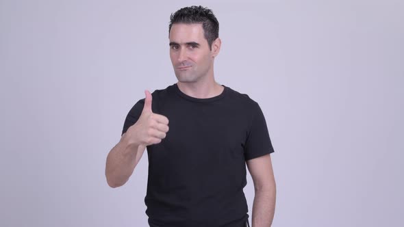 Happy Handsome Man Giving Thumbs Up Against White Background