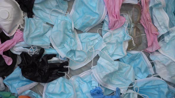 COVID-19 Waste Pollution crisis. Used discarded disposable face masks and latex gloves