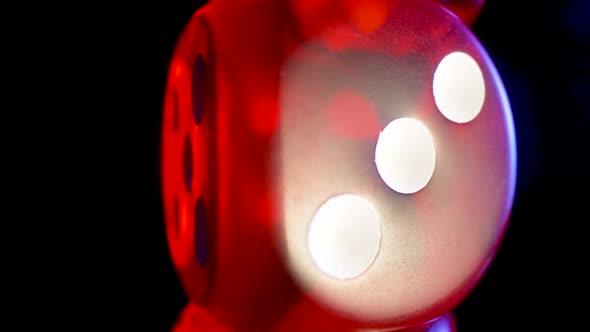 Red Dice Spinning on an Isolated Black Background