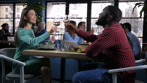 Young Couple Raising and Clinking Glasses of Wine