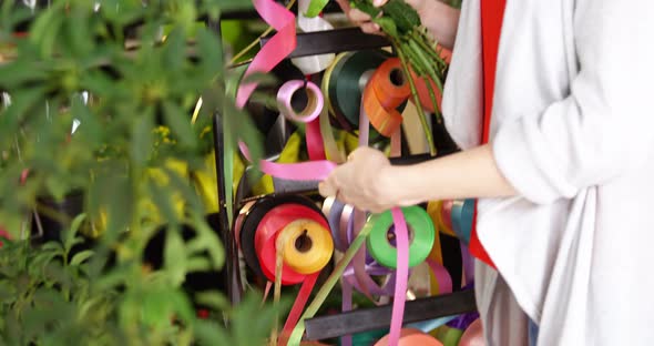 Female florist preparing a bunch of flower in flower shop