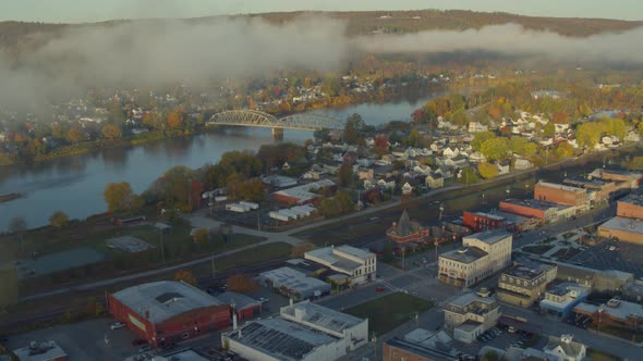 Aerial pulling away from the Delaware River to reveal Port Jervis and Matamoras