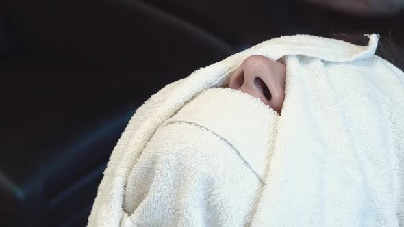 Young Man Was Wrapped Up in a Towel Prepared to Decorate His Beard and Mustache in a Barber Shop