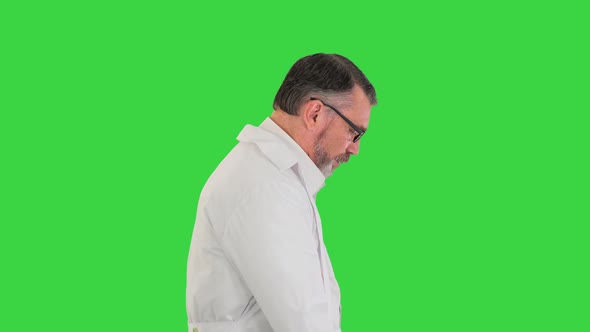 Sad Male Doctor in Glasses Walking on a Green Screen Chroma Key