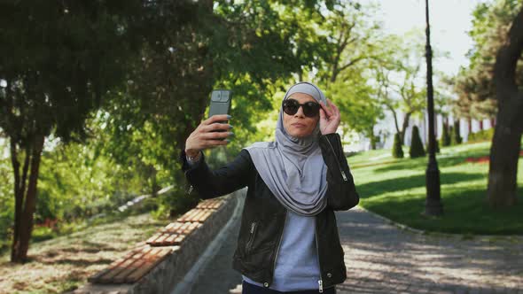 Muslim Female in Casual Clothes Sunglasses and Hijab