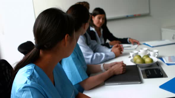 Team of doctors applauding during a meeting