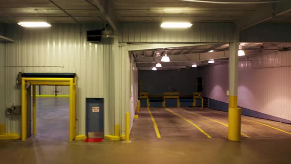 Cinematic Dolly Shot in Empty Loading Dock for Heavyweight Cargo Trucks Garage