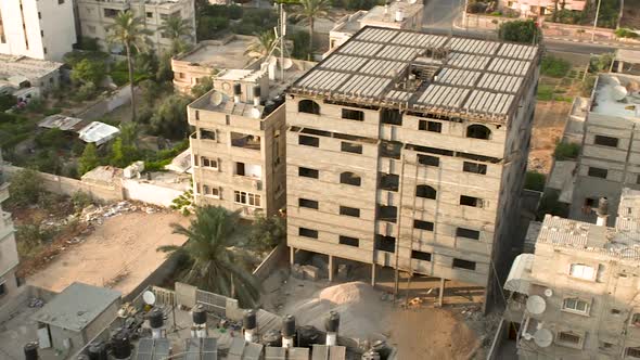 Pan of several unfinished high rise buildings in Gaza.