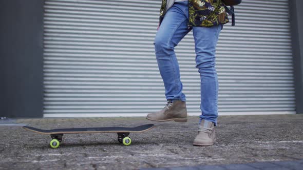 Albino african american man holding skateboard