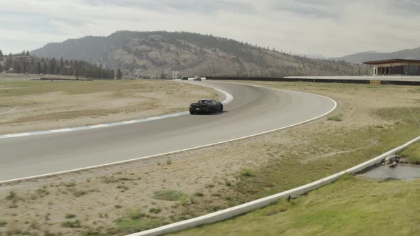 Exotic sports cars driving on a racing circuit, Osoyoos race track, Luxury Motorsports Club, Canada.