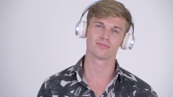 Face of Young Handsome Tourist Man Listening To Music and Relaxing