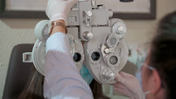 Eyesight Measurement to Young Woman with Optical Phoropter