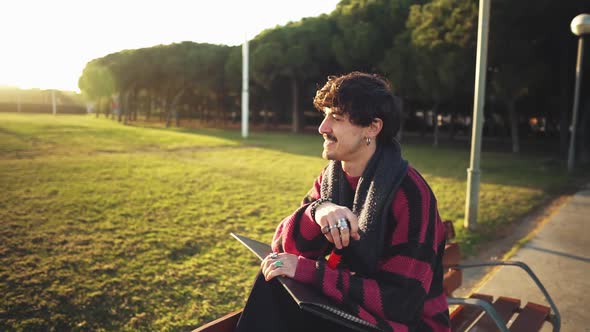 Modern Young Stylish Male Paint Artist Drawing Sketches in Park