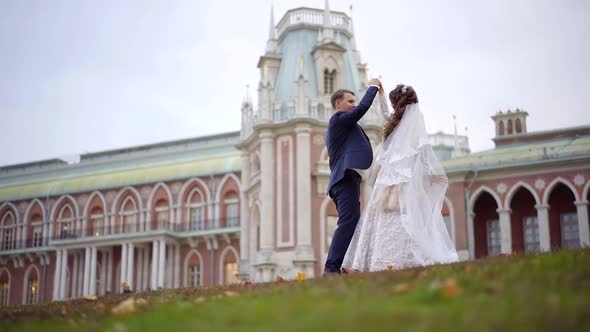 Happy Newlyweds Are Dancing in Wedding Day Outdoors in Autumn, Smiling,holding Hands, Girl Is