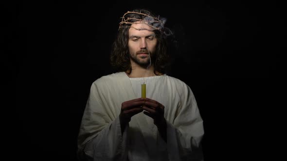 Jesus in Crown of Thorns Holding Smoking Candle, Disappearing in Darkness, Death