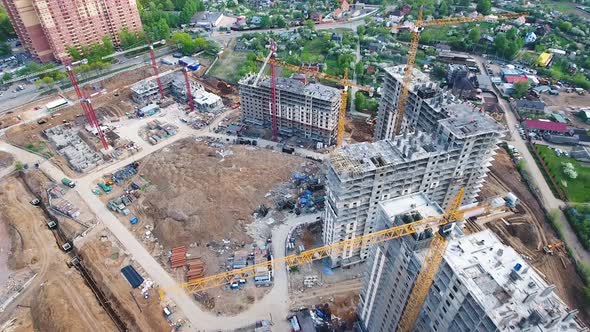 Drone flies over a construction site near Moscow. Construction cranes in the industrial zone. 