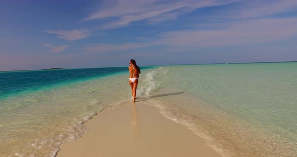 Modern fun woman on holiday enjoying life at the beach on sunny blue and white sand background