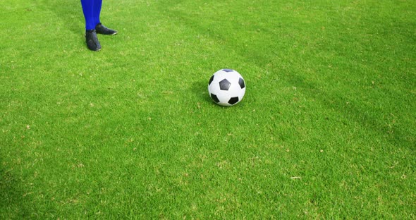 Football player kicking a ball in the field