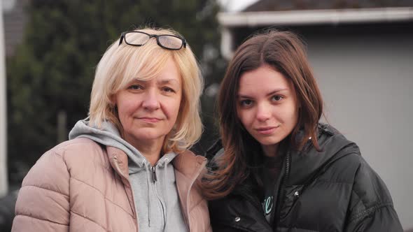 Mature Mother and Young Daughter Video Portrait Together Outdoors on a Windy Cold Day