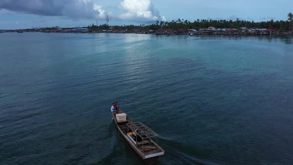 Two People Using a Motorboat in the Shallow Sea. Banyak Island