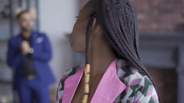 Portrait of Sad African American Woman with Problem Skin Standing in the Foreground While Her