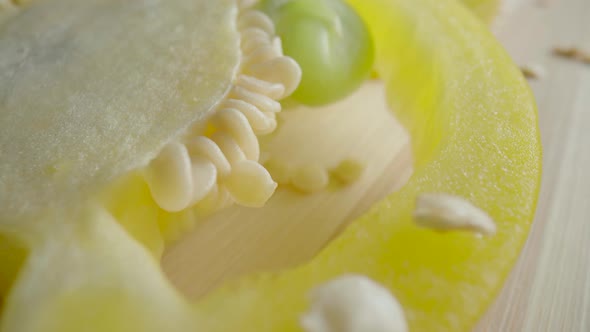 Sliced Rings of Fresh Raw Yellow Bell Peppers on Wooden Board