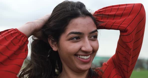 Young latin woman having fun at city park