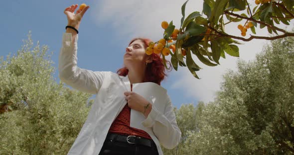 Young agronomist checks the medlar in the countryside