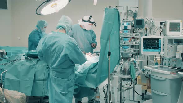 Operating Theatre with a Surgery Being Performed By Doctors