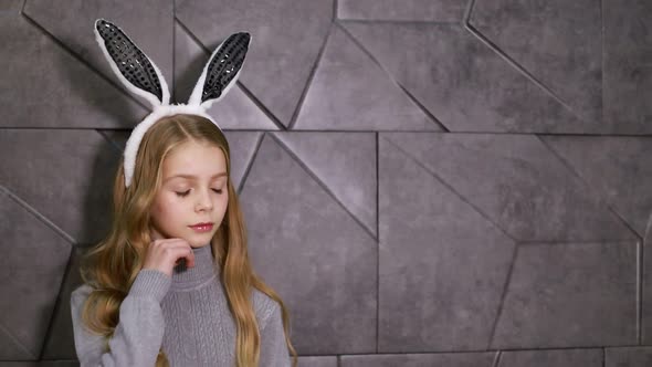 Cute Little Girl Dressed in the Ears of an Easter Bunny a Happy Child is Waiting for the Holidays