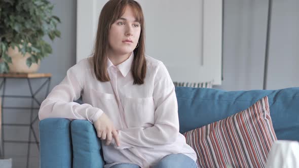 Casual Girl Sitting on Couch at Home