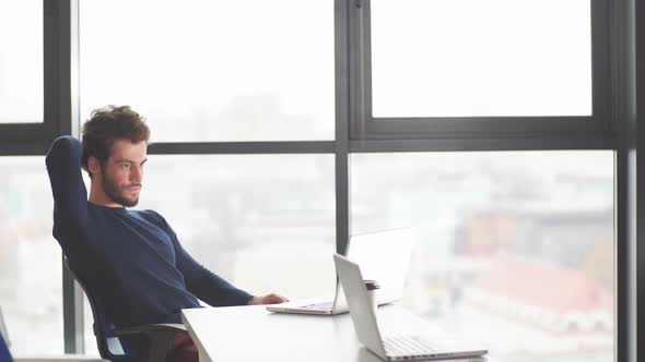 Portrait of Young Male Student Working at Using Laptop