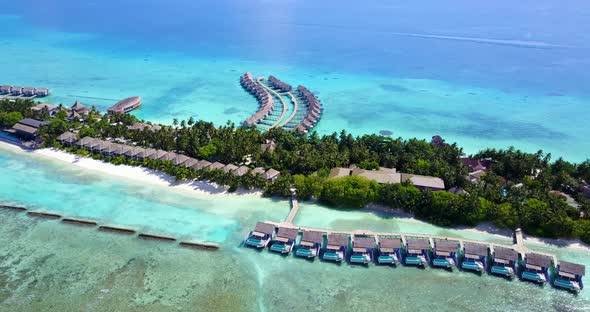 Wide angle flying tourism shot of a sunshine white sandy paradise beach and blue sea background in c