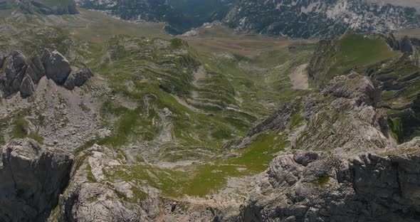 aerial slider view of valley in mountains with rocks