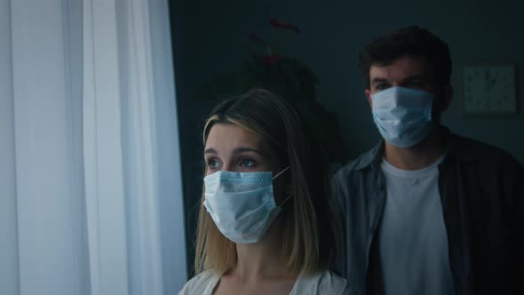 Sad Man and Woman Wearing Protective Medical Mask on Face