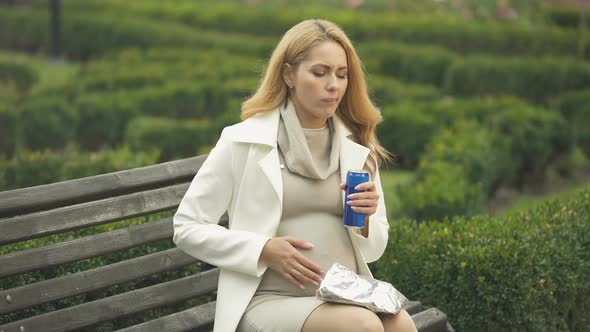 Irresponsible Expectant Drinking Unhealthy Soft Drink on Bench, Baby Health Care