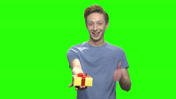 Teenage Young Boy with Gift Box and Thumb Up