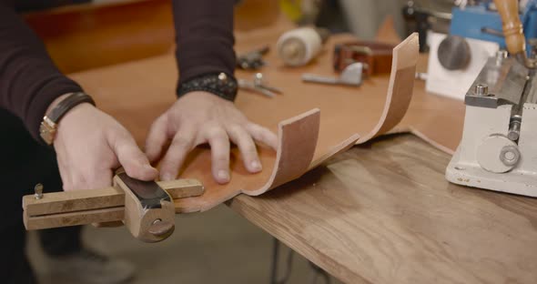 Craftsman Working with Leather in a Workshop