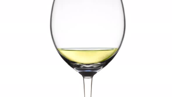 Goblet Filling Up with Sparkling Wine on White Background